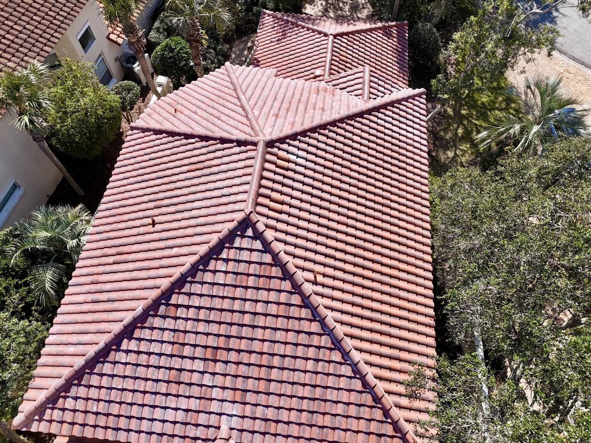 Clay barrel tile roof detail showing hip ridge and field tile courses